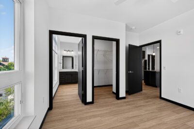 Vicino Apartments bedroom hallway with views into bathroom, walk-in closet, and kitchen