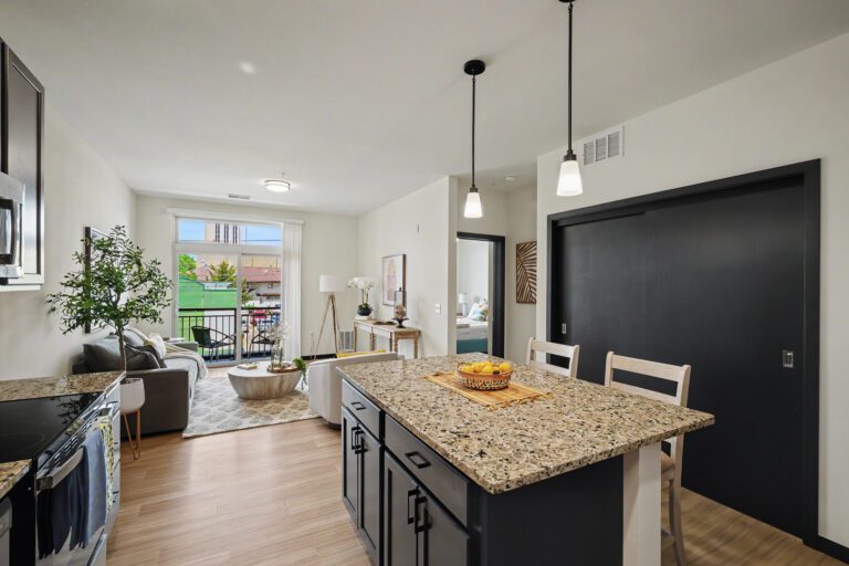 Vicino Apartments open-concept living room and kitchen with granite island and private balcony