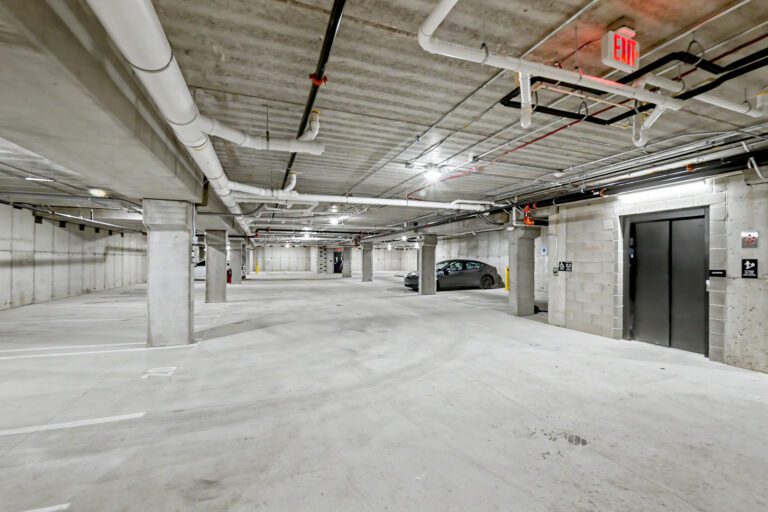 Underground parking garage at Vicino Apartments with resident parking and elevator access