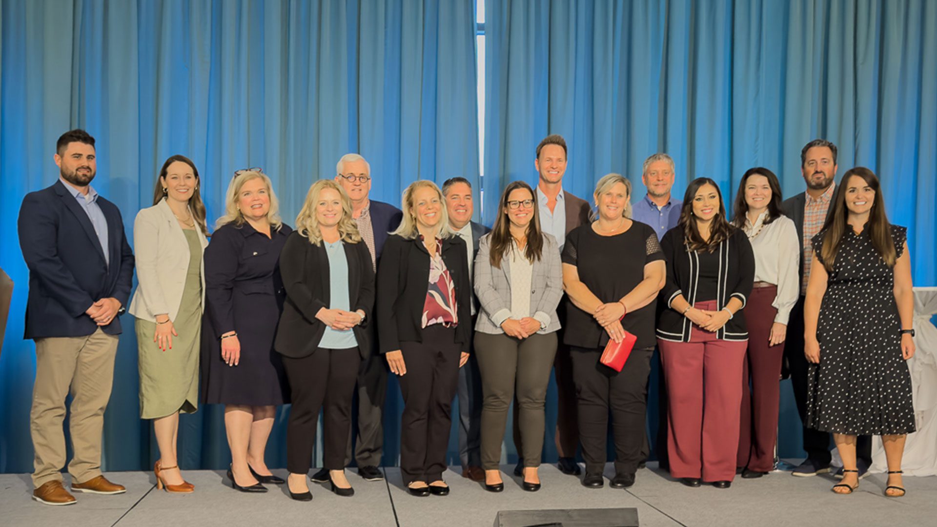 Finalists and winners of the In Business Madison Executive Excellence Awards standing together on stage at the Edgewater
